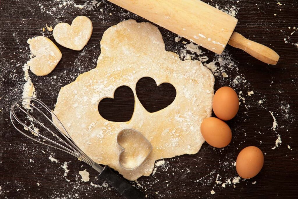 prayer for emotional eating - pie crust rolled out with heart cookie cutter, whisk, and eggs