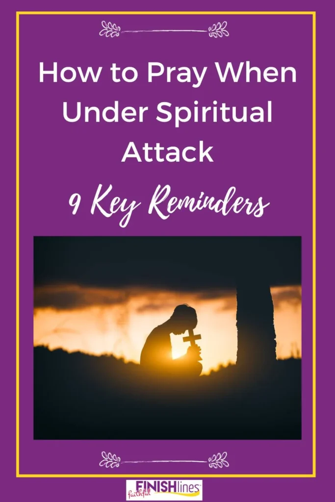 how to pray when under spritual attack - a person holding a cross.