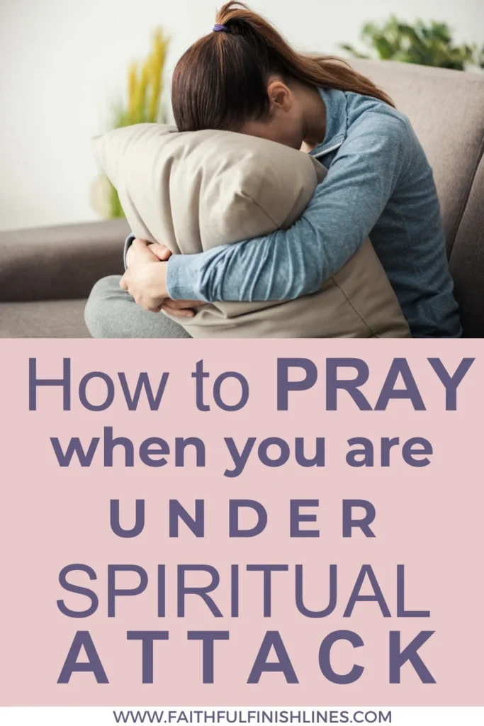 A woman hugging a pillow with a text overlay that reads as How to Pray When Under Spiritual Attack—9 Key Reminders.